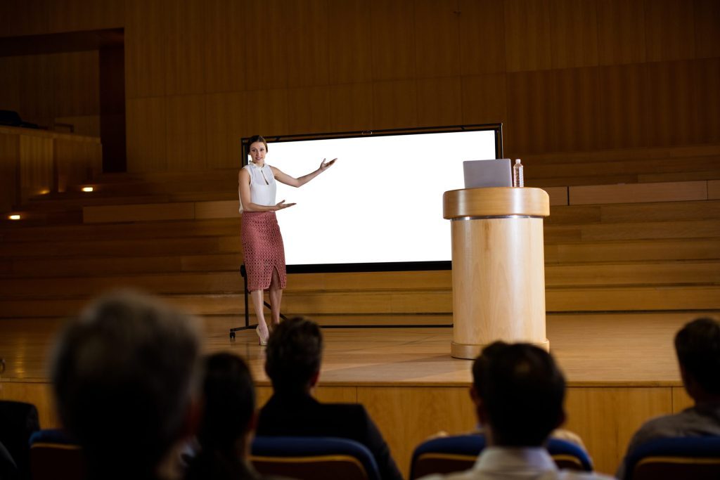 Female business executive giving presentation at conference center