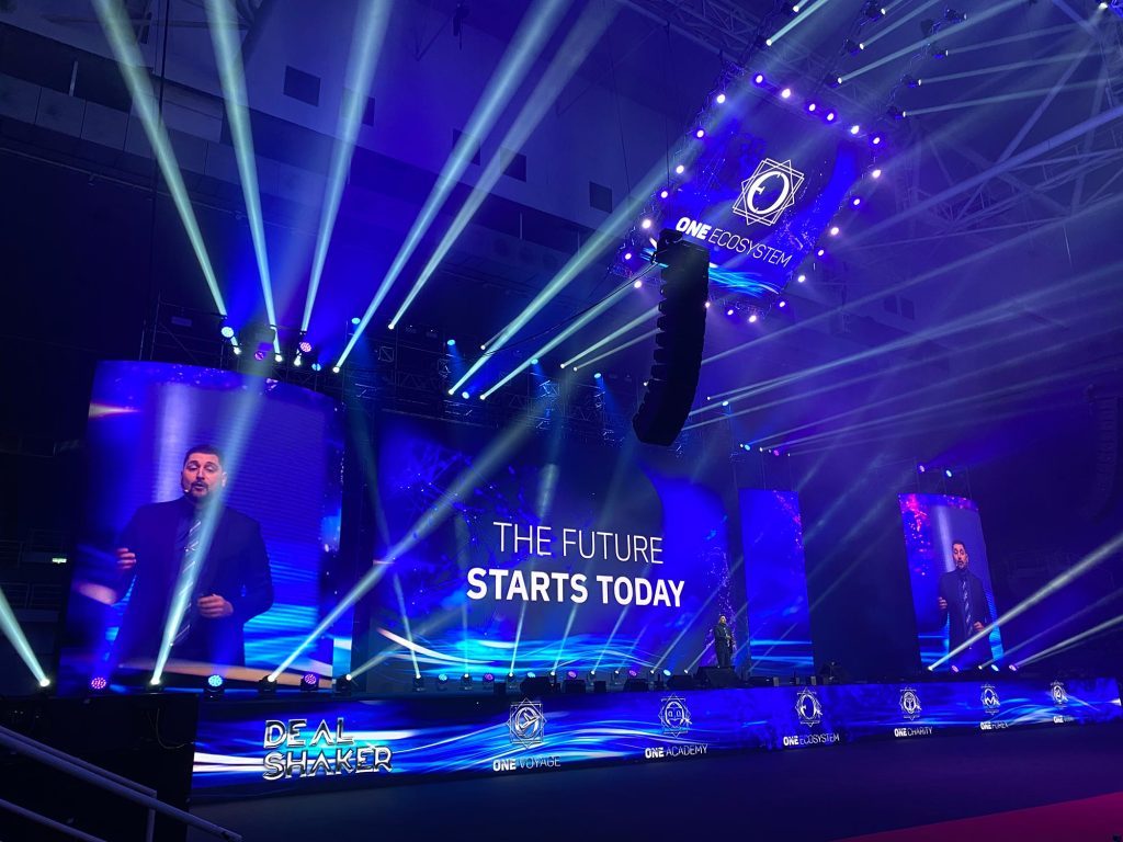 Curved LED screen used as a stunning stage backdrop for a gala dinner, displaying vibrant visuals that complement the event's theme, enhancing the atmosphere with dynamic imagery and engaging lighting effects.