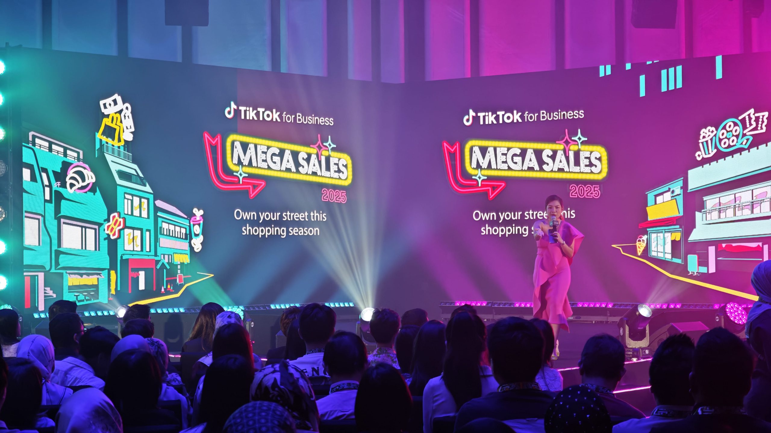 Corporate event backdrop combining an LED screen, branded panels and stage lighting