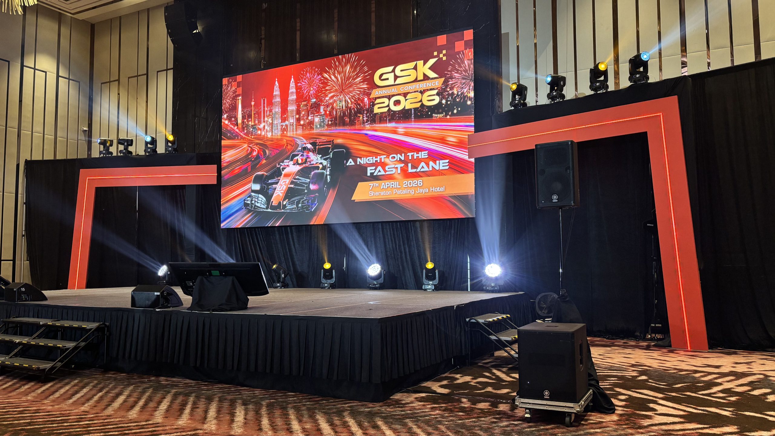 Professional audiovisual equipment setup with LED screens, microphones and stage lighting at a corporate conference