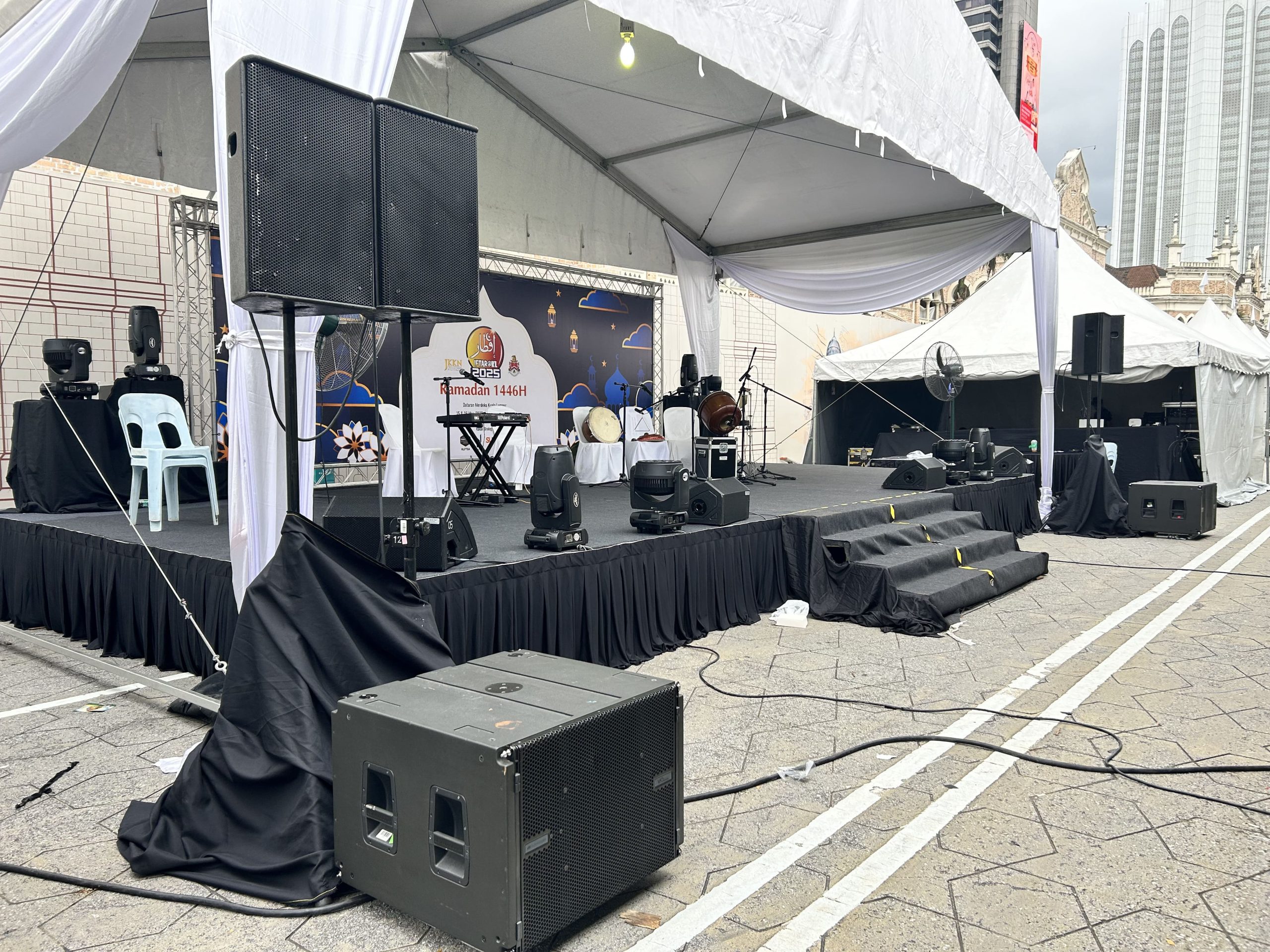 Sound system rental setup with speakers and microphones for an event