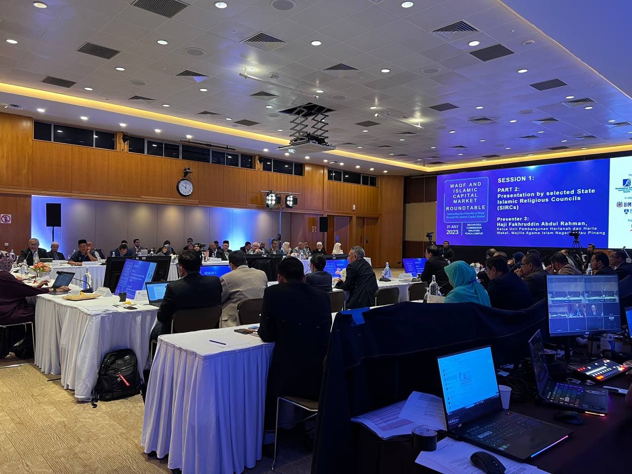 Professional audiovisual equipment setup with LED screens, microphones and stage lighting at a corporate conference